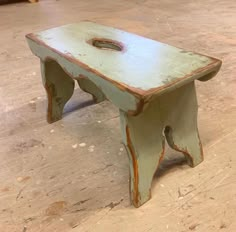 an old wooden bench sitting on top of a hard wood floor