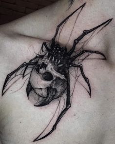 a black and white tattoo on the chest of a man with a large spider in it's abdomen