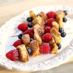 berries and french toast on a plate with powdered sugar