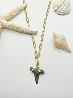 One of a kind unique shark tooth necklace. This listing is for 1 authentic fossilized shark tooth necklace that hangs from a gold paperclip chain. All teeth are found by me in the Gulf of Mexico 🦈 🌊  NECKLACE: * Chain Material: pleated linked chains * Sizing: 4 x 11 mm   * Necklace length: 18"  * Wire color: Gold PENDANT: * Authentic Fossilized Shark Tooth  * Each shark tooth is found by me in the Gulf of Mexico and they are unique to itself  * The listing is not for the tooth in the photo, bu Shark Tooth Necklace Mens, Beaded Shark Tooth Necklace, Shark Necklace Tooth, Silver Shark Tooth Necklace, Shark Tooth Pendant, Recycled Necklaces, Gold Spoon, Shark Tooth Necklace, Spoon Necklace