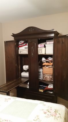 an armoire in the corner of a bedroom