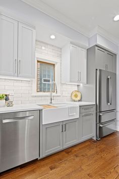 a kitchen with stainless steel appliances and wood floors