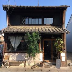 an old building with plants growing out of it's windows and on the outside