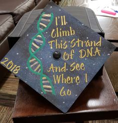 a graduation cap that says i'll climb this strand of dna and see where i go