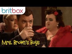 the man and woman are drinking from wine glasses in front of each other, with text that reads mrs brown's boys