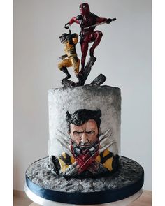 a cake decorated with an image of wolverineman and deadpool on top of it