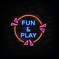 fun and play neon sign with arrows on dark brick wall background stock photo - 1389782