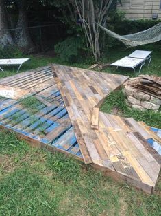 an upside down wooden structure in the grass