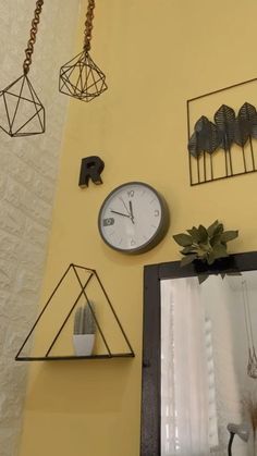 there are many different types of clocks on the wall above the mirror in this room