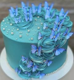 there is a blue cake with flowers on it