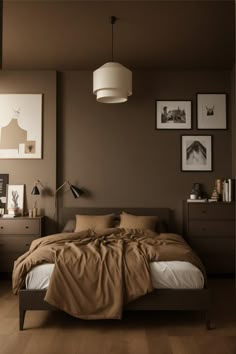 a bed sitting in a bedroom next to a wall with pictures hanging on the walls