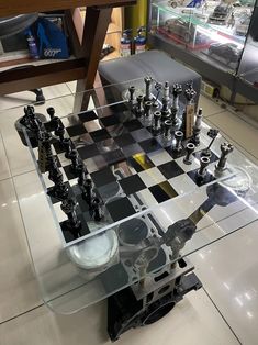 a glass table with chess pieces on it