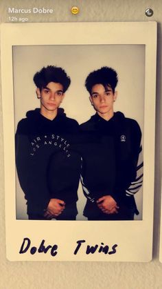 two young men standing next to each other in front of a white frame with the words dobre twins on it