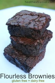 three brownies stacked on top of each other with text overlay that reads flourless brownies gluten free + dairy - free