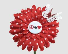 a red flower with white polka dots and a peace sign on it