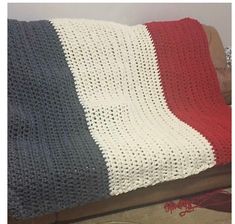 a crocheted blanket sitting on top of a couch