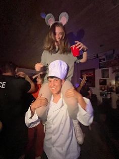 a woman is holding onto a man in bunny ears