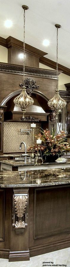 a large kitchen with marble counter tops and an island