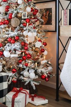 a decorated christmas tree with red, white and silver ornaments