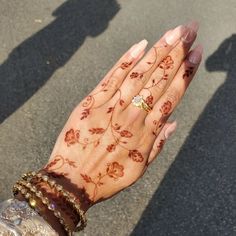 a woman's hand with henna on it