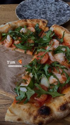 a pizza with shrimp and arugula on it