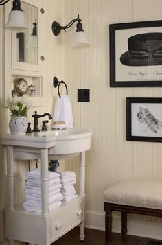 a white sink sitting under a bathroom mirror