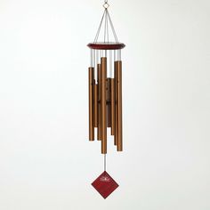 a wind chime hanging from the side of a white wall