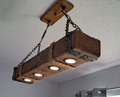 a wooden light fixture hanging from the ceiling