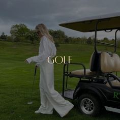 a woman standing next to a golf cart