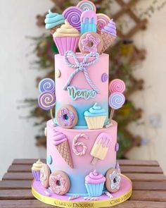 a three tiered cake decorated with donuts and candy