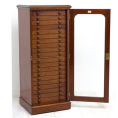 an antique wooden jewelry cabinet with mirror on the front and back doors open to reveal it's contents