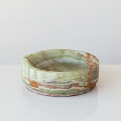 a marble bowl sitting on top of a white table