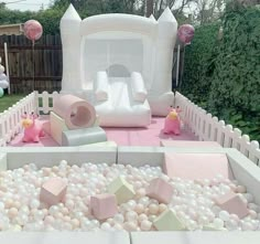 an inflatable play area with pink and white balls