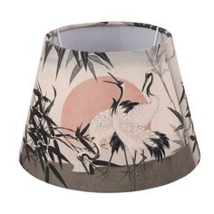 a lamp shade with cranes and bamboo leaves on it