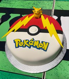 a pokemon cake is decorated with pikachu and lightning bolt on the top layer