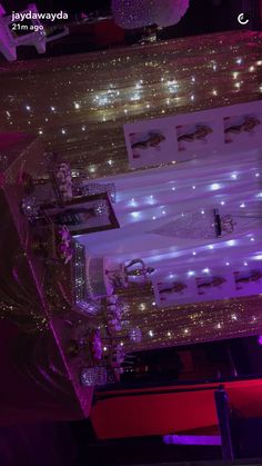 the table is decorated with purple lights and silver decorations on it, along with other items