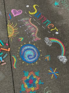 the sidewalk is covered with chalk and crayons