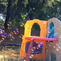 a child's play area with soap bubbles floating in the air and on top of it