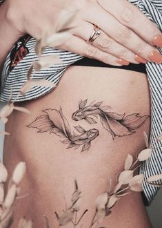 a woman's stomach with a dragon tattoo on her lower thigh and the bottom part of her belly