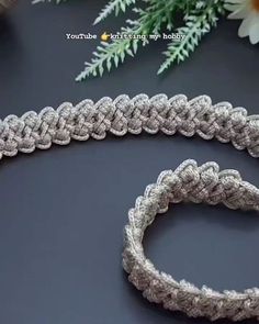 a close up of a rope on a table with flowers in the background and text overlay that reads, how to crochet