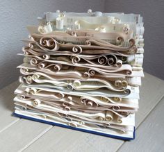 a stack of folded papers sitting on top of a table