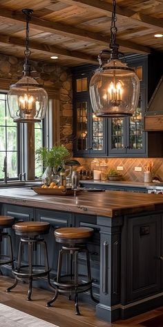 a kitchen with wooden floors and lots of lights hanging from the ceiling over the island