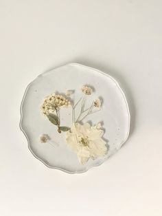 a white plate with some flowers on it