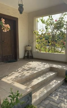 an outdoor patio with steps leading up to the front door