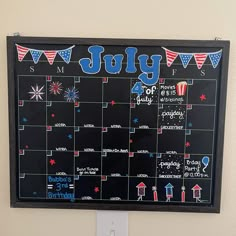 a chalk board with the word july written on it