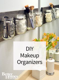 mason jars are lined up on the wall to hold makeup brushes and other personal care items