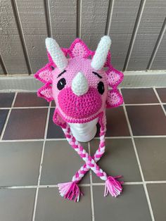 a pink and white crocheted animal hat