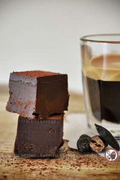 two pieces of chocolate cake next to a cup of coffee