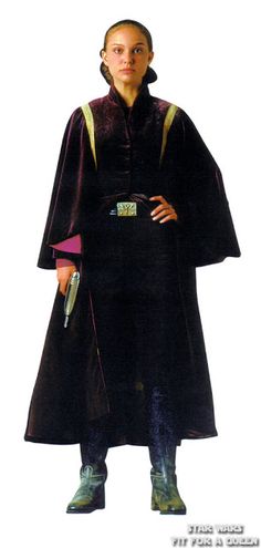 a woman in a black robe and green shoes standing with her hands on her hips