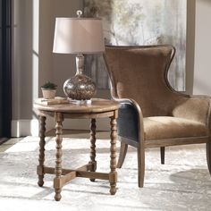 a living room scene with focus on the end table and chair next to the lamp